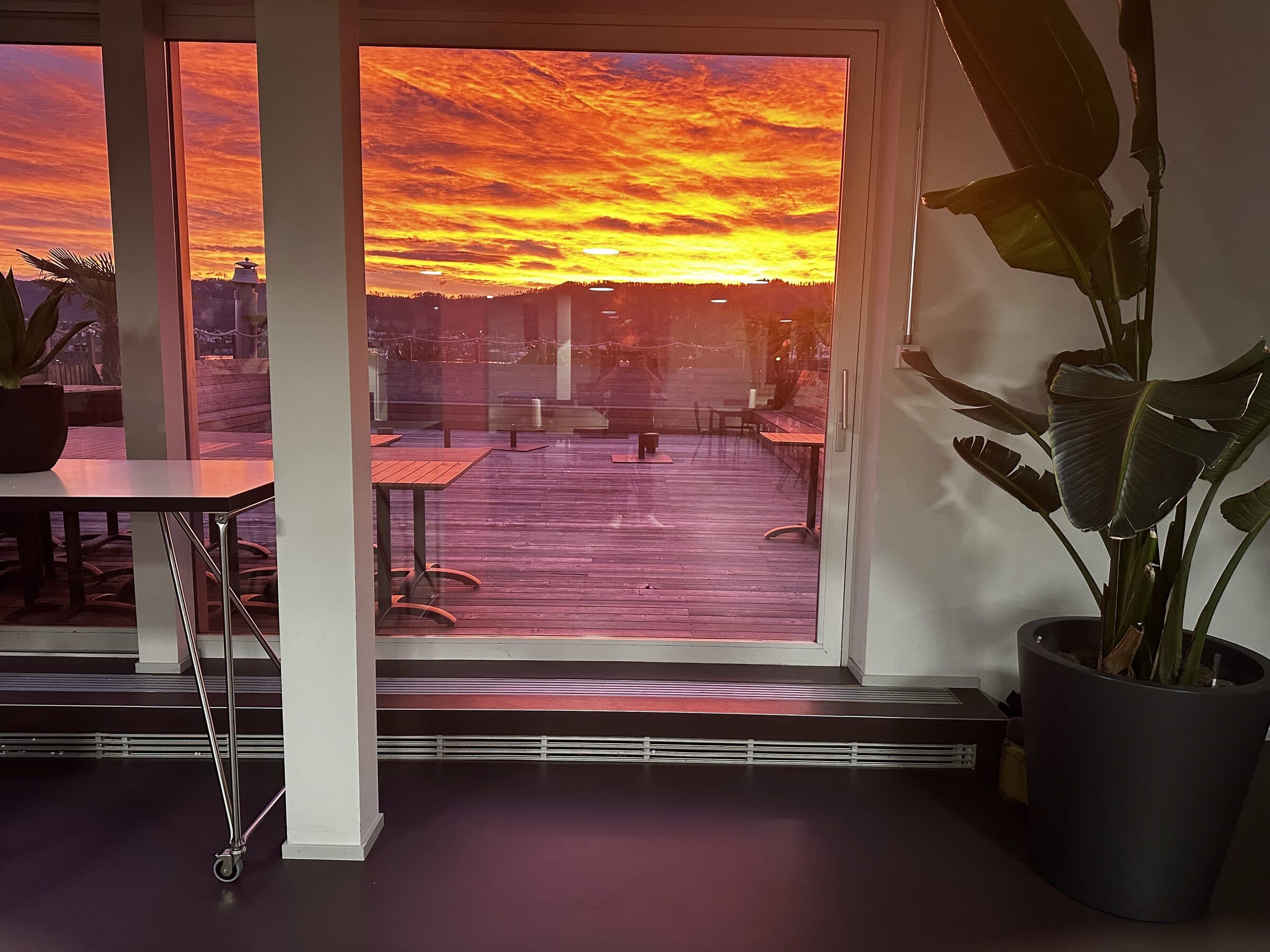 Lounge with view onto the terrace at sunset