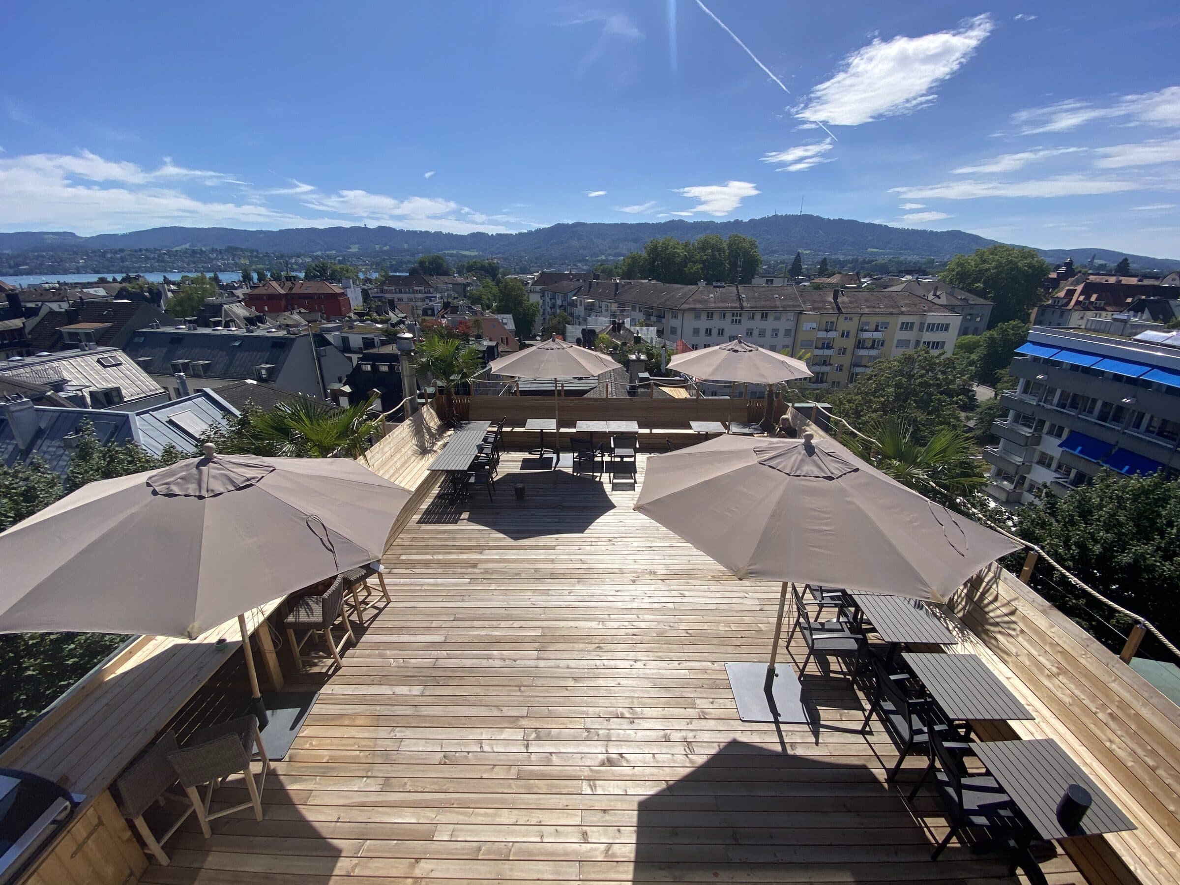 Rooftop terrace with parasols and a view over Zurich